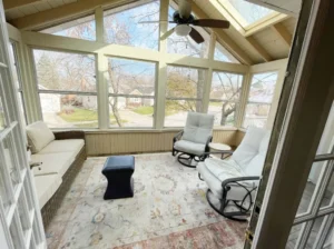 Bright sunroom with comfortable seating. Home improvement services.