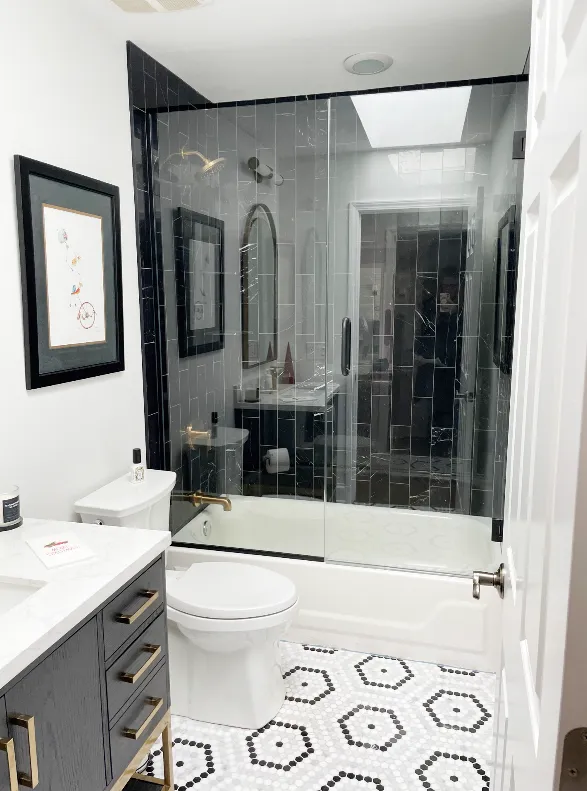 Modern bathroom with black and white tiles. Bathroom renovation Oswego, Illinois.