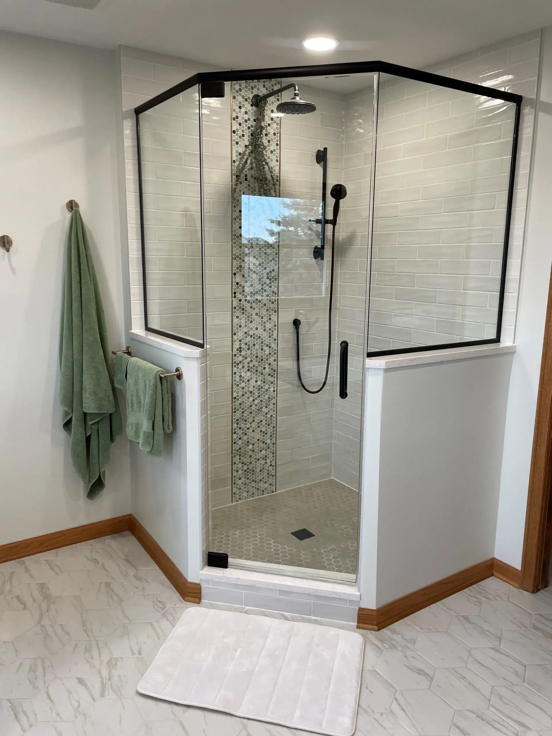 Modern corner shower with black framing. Bathroom renovation Oswego, Illinois.