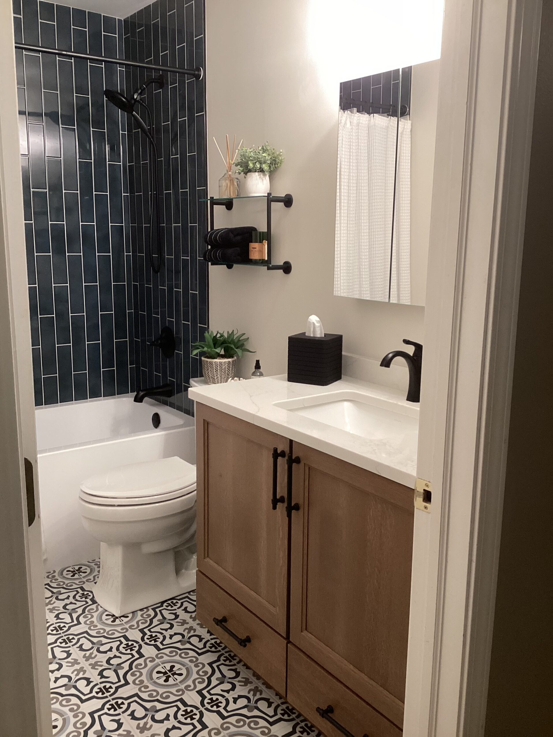 New tile in shower, painted walls, added a vanity, countertop, and new bright lighting.